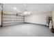 Spacious two-car garage with gray epoxy floor, ample lighting and storage space at 6005 Ike Smith Rd, Plant City, FL 33565