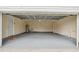 Spacious two-car garage features ample storage space, fresh paint, and a side entry door at 6005 Ike Smith Rd, Plant City, FL 33565