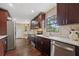 Bright and modern kitchen featuring stainless steel appliances, dark wood cabinets, and a view of the backyard at 6005 Ike Smith Rd, Plant City, FL 33565