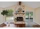 Living room features a stone fireplace and sliding door with ample natural light at 6005 Ike Smith Rd, Plant City, FL 33565