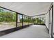 Covered, screened patio with concrete flooring and black frames at 6005 Ike Smith Rd, Plant City, FL 33565