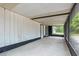 View of a covered, screened patio with black trim and concrete flooring at 6005 Ike Smith Rd, Plant City, FL 33565