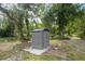 Durable metal storage shed on a concrete slab pad with water access, surrounded by mature trees at 6005 Ike Smith Rd, Plant City, FL 33565