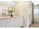 Well-lit bathroom with a double vanity, large mirror, modern fixtures, and a separate toilet and shower area at 6014 Jensen View Ave, Apollo Beach, FL 33572