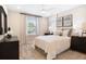 Well-lit bedroom with a large window, stylish décor, and a comfortable-looking bed at 6014 Jensen View Ave, Apollo Beach, FL 33572