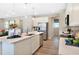 Open concept kitchen with a large island, stainless steel appliances, and modern finishes at 6014 Jensen View Ave, Apollo Beach, FL 33572