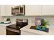Gourmet kitchen features stainless appliances, modern countertops, and a contemporary design at 6014 Jensen View Ave, Apollo Beach, FL 33572