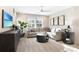 Cozy living room with plush seating, large windows, modern decor, and a sleek entertainment center with a beach scene TV display at 6014 Jensen View Ave, Apollo Beach, FL 33572