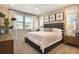 Comfortable bedroom with neutral color scheme, plush bedding, large windows with bright natural light, and modern furnishings at 6014 Jensen View Ave, Apollo Beach, FL 33572