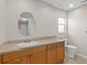 Functional bathroom featuring a vanity with drawers, toilet, neutral walls and lighting at 14010 102Nd Ave, Largo, FL 33774