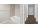 Modern bathroom with tile shower/tub and a view into the hall at 14010 102Nd Ave, Largo, FL 33774