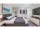 Comfortable bedroom with a queen bed, stylish lamps, and modern decor and closet for storage at 14010 102Nd Ave, Largo, FL 33774