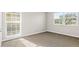 A bright bedroom featuring carpet floors, natural light, and neutral walls at 14010 102Nd Ave, Largo, FL 33774