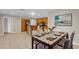 Bright dining room with view into the kitchen, featuring stainless appliances, and a modern dining table at 14010 102Nd Ave, Largo, FL 33774