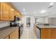 Open kitchen featuring tile flooring, stainless appliances, and wood cabinetry at 14010 102Nd Ave, Largo, FL 33774