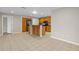 Open kitchen with stainless steel appliances, wood cabinetry, and tile flooring offers a functional space at 14010 102Nd Ave, Largo, FL 33774