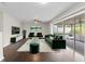 Staged living room showcases dark hardwood flooring and sliding glass doors leading to the outdoor area at 14010 102Nd Ave, Largo, FL 33774