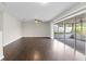 Spacious living room with dark hardwood flooring, ceiling fan, and sliding glass doors to a screened-in porch at 14010 102Nd Ave, Largo, FL 33774