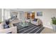 Staged living room showcasing neutral tones, tile floors, and plenty of natural light at 14010 102Nd Ave, Largo, FL 33774