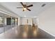 Hardwood flooring, ceiling fan, and access to the lanai through sliding glass doors enhance this versatile living area at 14010 102Nd Ave, Largo, FL 33774