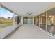 Relaxing screened patio features sliding glass doors, ceiling fan, and backyard views at 14010 102Nd Ave, Largo, FL 33774