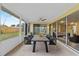 Inviting screened patio features a dining table, backyard views and access to the living room at 14010 102Nd Ave, Largo, FL 33774