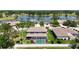 Expansive aerial view of the home featuring a pool, lake, and beautifully landscaped surroundings at 16219 Turnbury Oak Dr, Odessa, FL 33556
