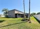Spacious backyard features mature trees, a well-manicured lawn, screened-in pool area, and privacy fencing at 16219 Turnbury Oak Dr, Odessa, FL 33556