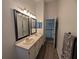 Bathroom showcasing a double sink vanity and a view towards a stairwell at 16219 Turnbury Oak Dr, Odessa, FL 33556
