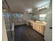 Bright and airy bathroom featuring a double vanity with wood cabinets and modern fixtures at 16219 Turnbury Oak Dr, Odessa, FL 33556