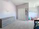 Bright bedroom features a closet, a neutral color scheme, and soft carpeting at 16219 Turnbury Oak Dr, Odessa, FL 33556