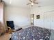 This bedroom offers a ceiling fan, carpeted flooring, neutral walls, and a double-door closet for storage at 16219 Turnbury Oak Dr, Odessa, FL 33556
