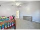 Bright bedroom with ceiling fan, closet, carpet, and an ensuite bathroom at 16219 Turnbury Oak Dr, Odessa, FL 33556
