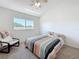 This bedroom features neutral walls, carpeted flooring, a ceiling fan, and a window with great natural light at 16219 Turnbury Oak Dr, Odessa, FL 33556