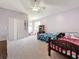 Spacious bedroom with ceiling fan, carpeted floors, closet, and two beds at 16219 Turnbury Oak Dr, Odessa, FL 33556