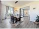 Dining room featuring a wooden table, decorative rug, modern lighting, and large windows at 16219 Turnbury Oak Dr, Odessa, FL 33556