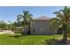 View of the home's exterior featuring lush landscaping, mature trees, and a well-maintained lawn at 16219 Turnbury Oak Dr, Odessa, FL 33556