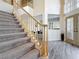 Foyer boasts soaring ceilings, natural light, and a staircase with carpeted steps at 16219 Turnbury Oak Dr, Odessa, FL 33556