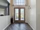 Well-lit foyer with hardwood floors, view of front door and living spaces at 16219 Turnbury Oak Dr, Odessa, FL 33556