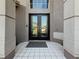 Grand front entrance with double doors, large windows, and tile flooring at 16219 Turnbury Oak Dr, Odessa, FL 33556