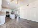 Well-lit kitchen with stainless steel appliances, a center island, and sleek hardwood floors at 16219 Turnbury Oak Dr, Odessa, FL 33556