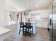 Bright kitchen and open-concept living space featuring an island with bar seating and modern appliances at 16219 Turnbury Oak Dr, Odessa, FL 33556