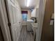 Functional laundry room with a utility sink, washer, dryer, and upper cabinets at 16219 Turnbury Oak Dr, Odessa, FL 33556