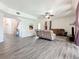 Open-concept living room boasts hardwood floors, ceiling fan, and comfortable seating at 16219 Turnbury Oak Dr, Odessa, FL 33556