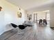 Inviting living room with modern decor, gray wood-look flooring, and an open-concept layout at 16219 Turnbury Oak Dr, Odessa, FL 33556