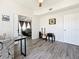 Office with view into adjacent living area with luxury vinyl plank flooring at 16219 Turnbury Oak Dr, Odessa, FL 33556