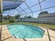 Screened-in pool and lush landscaping perfect for outdoor enjoyment at 16219 Turnbury Oak Dr, Odessa, FL 33556