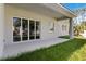 Covered patio and backyard with a large sliding glass doors at 4344 Jaslo Ave, North Port, FL 34286