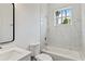 Modern bathroom featuring a tub, shower, new fixtures, and tile at 4344 Jaslo Ave, North Port, FL 34286