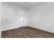 A simple bedroom with wood flooring and white walls, showing a serene and uncluttered living space at 4344 Jaslo Ave, North Port, FL 34286